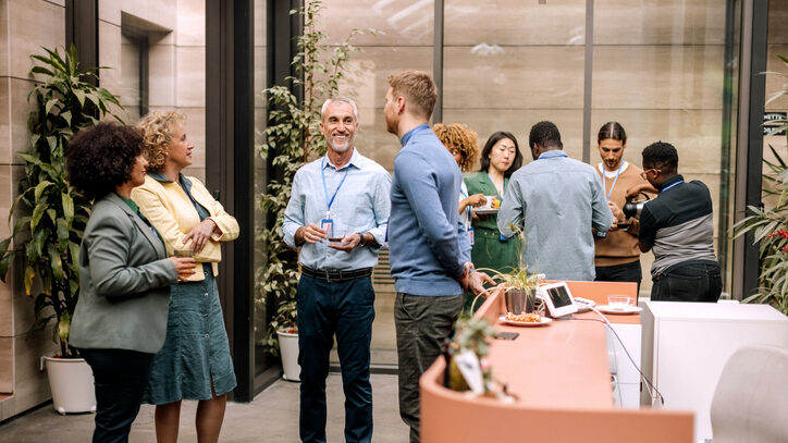 Group of business people having casual conversation while on a refreshment break